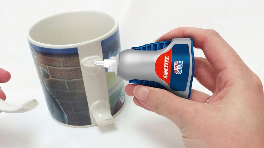 Person repairing mug with Loctite Super Glue.