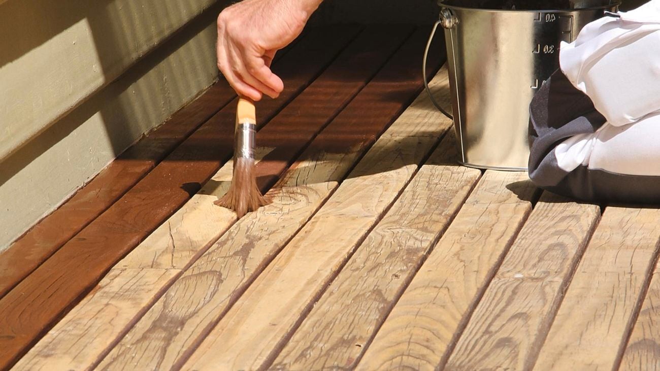 Decking oil being applied to outdoor deck.