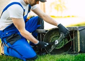 Man servicing a lawn mower.