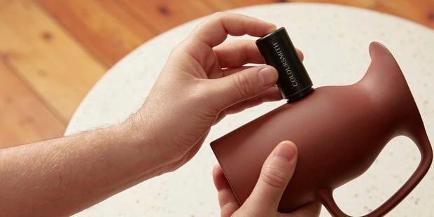 Person using the Coloursmith reader on a clay jug to match colour 