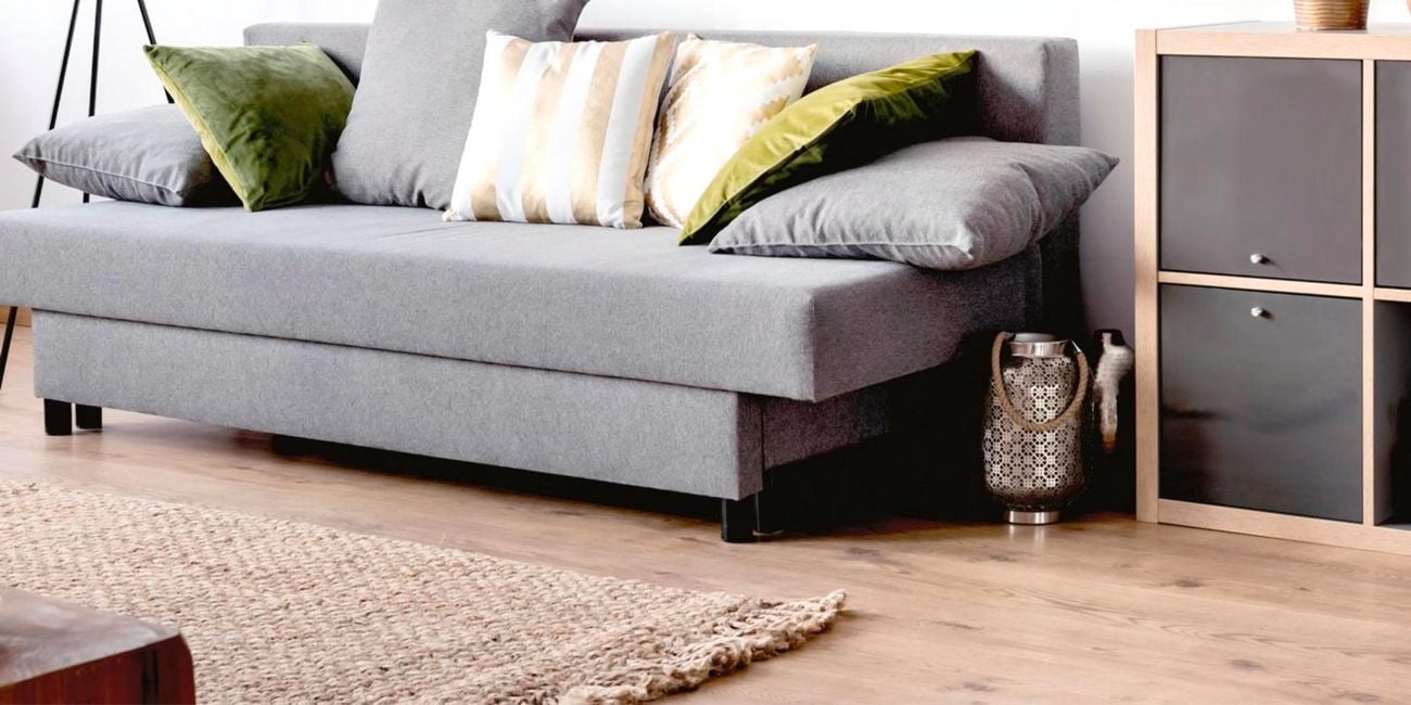 Couch in a living room with a rug