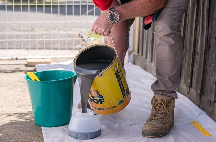 A Bunnings team member preparing the paint.