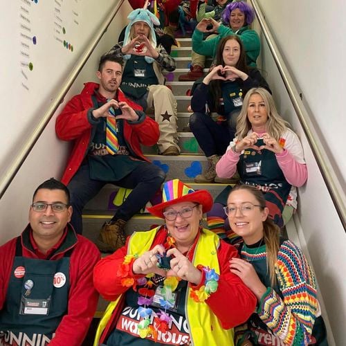 Team are on a staircase with love hearts in acceptance. 