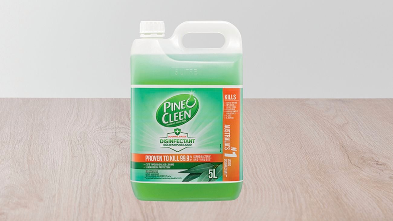 Disinfectant product sits on hardwood floor.
