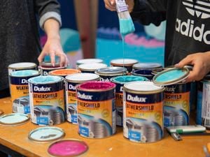 Tins of colourful paint.