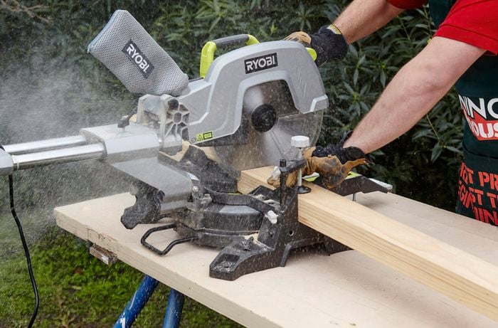 A mitre saw being used to cut lengths of timber to size