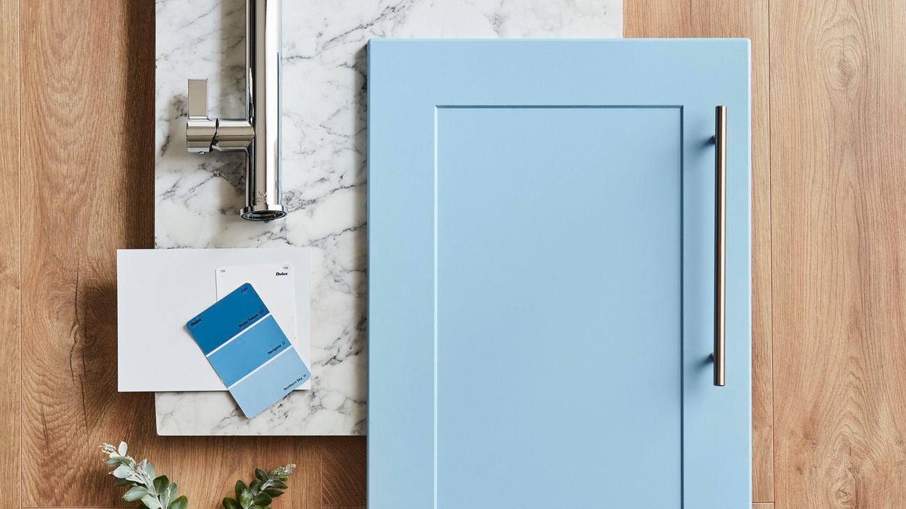 Marble benchtop, silver tap and paint colour samples.