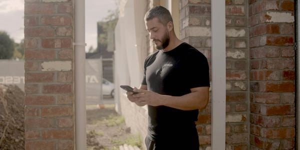 Person on the phone outside of a building site