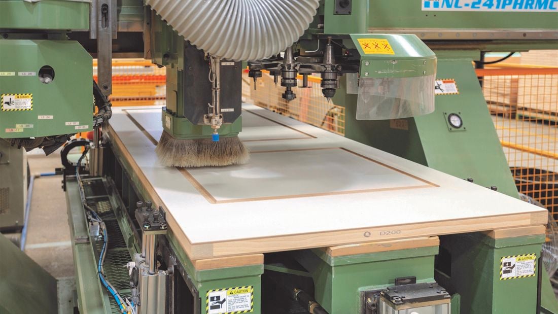 Machinery in a factory manufacturing a new door