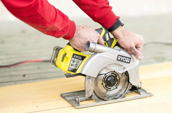 A circular saw being used to cut a panel of wood