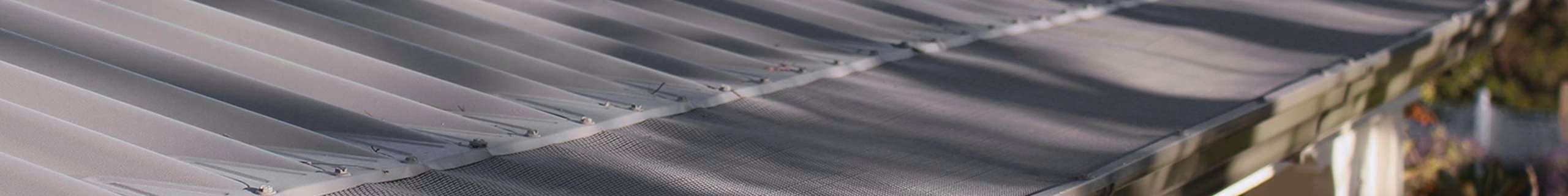 Close up of a roof with a gutter mesh.