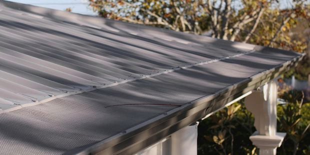 Close up of a roof with a gutter mesh.