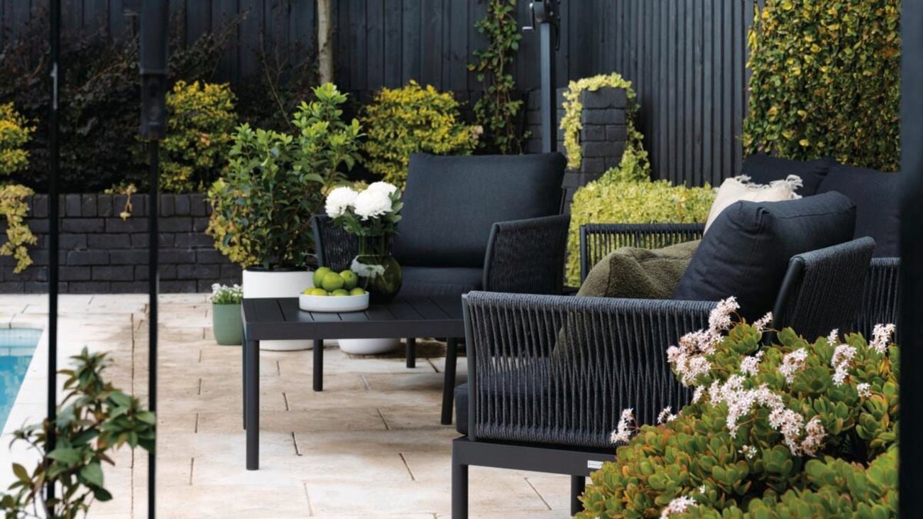 Outdoor patio setting with black shade umbrella.