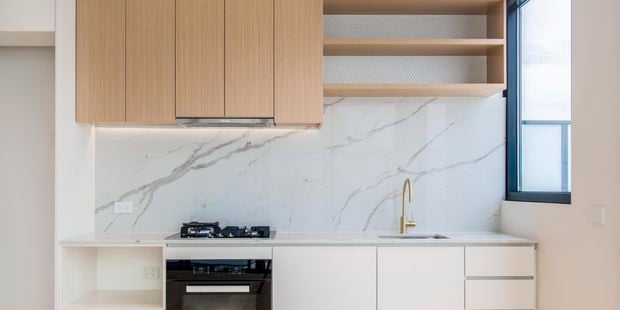 Kitchen - White cabinetry - Timber cabinets - Gold tapware - Marble splashback - Apartment - Wide