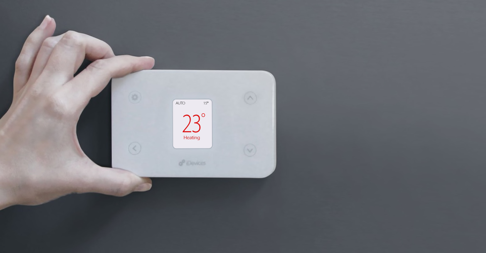 Person with hand around digital thermostat
