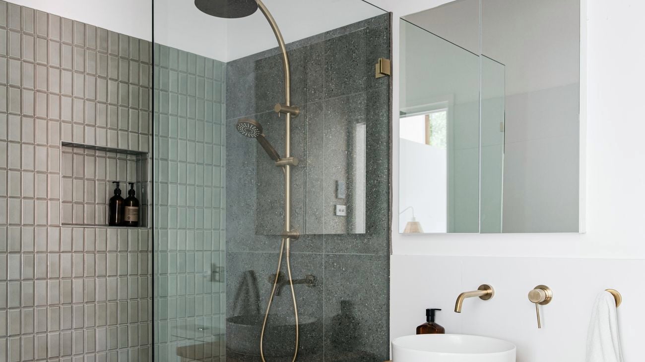 Modern bathroom featuring a dark tiled shower