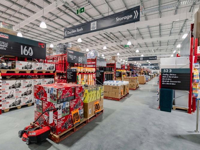 Wide interior view of a Bunnings store, specifically the garden tools section.