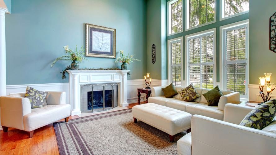A modern lounge room with furniture in it and a fireplace.