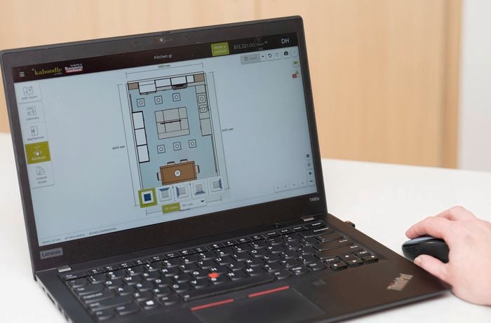 A person uses 3D kitchen design software to create a general lighting plan.  