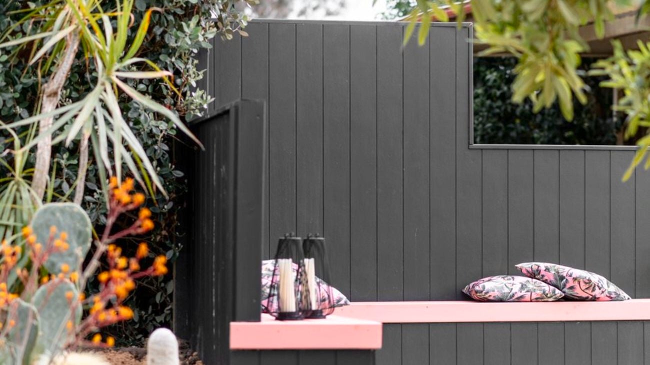Outdoor black timber fence with black timber bench