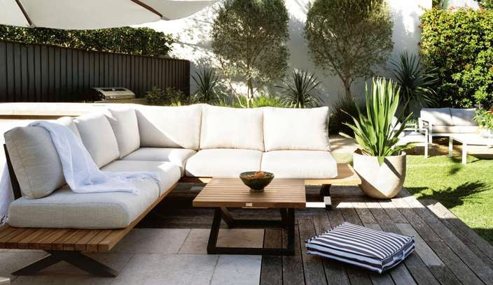 Outdoor furniture and an outdoor umbrella in a backyard