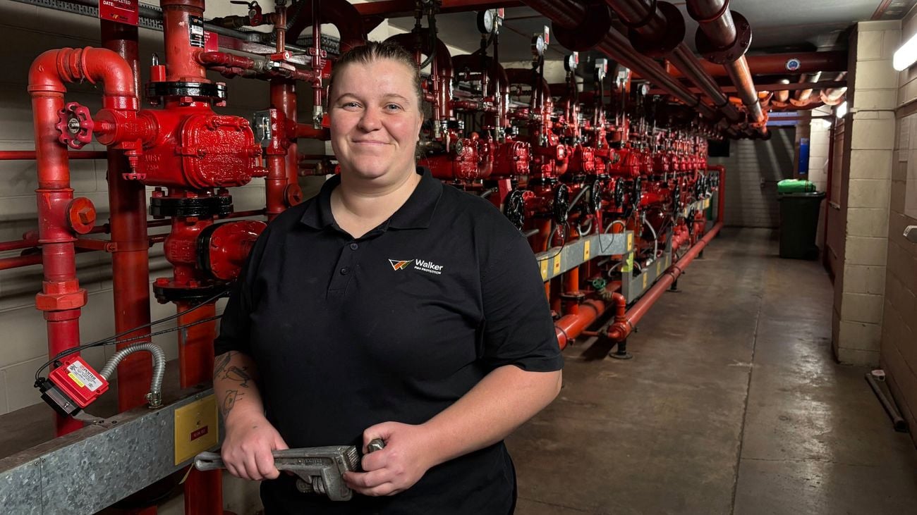 Women In Apprenticeships Awards winner 2025 Ella Gillon holding a wrench standing in front of sprinkler fitting services.