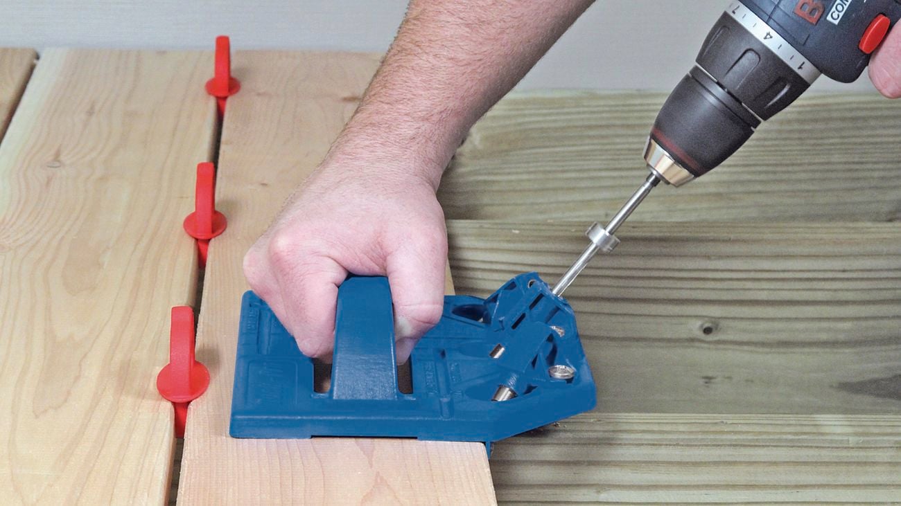 Person drilling into timber.