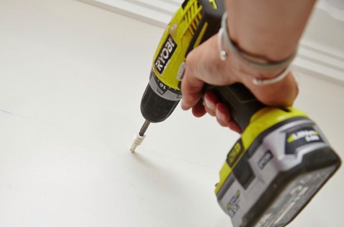 Wall plugs being drilled into a wall to cater for wall mounted brackets