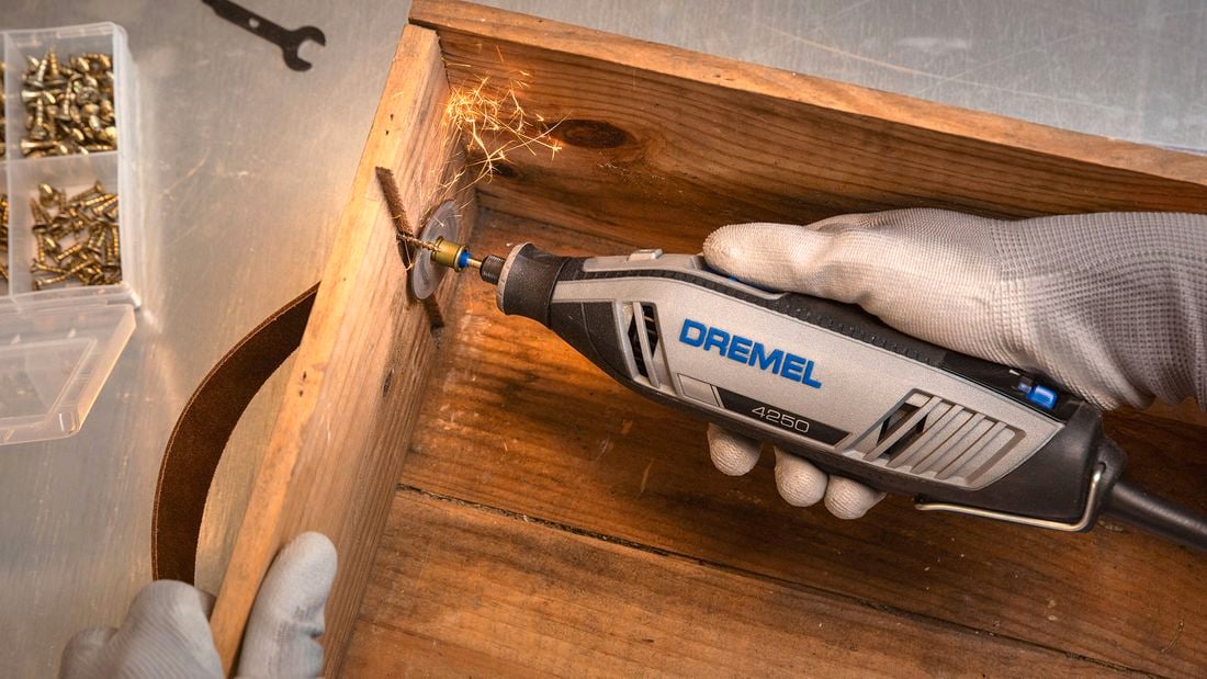 Dremel tool being used to make a cut 