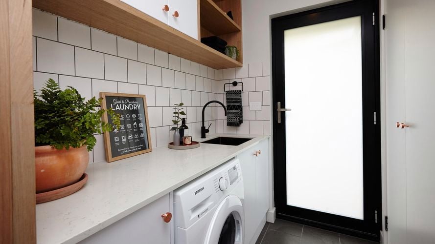 laundry room with machine, cabinets