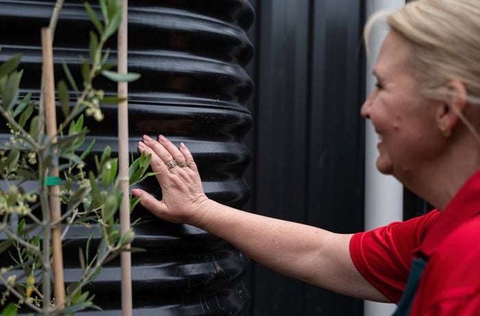 Bunnings team member touching the water tank