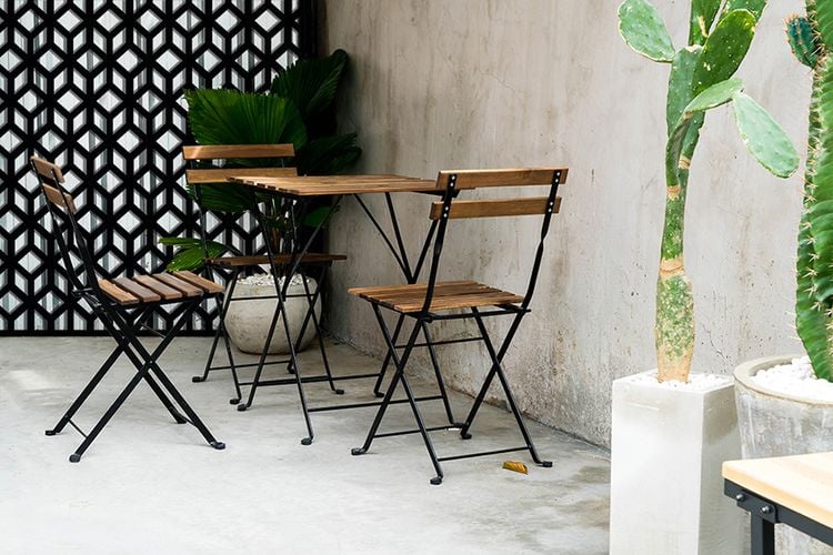 Small outdoor timber table set with decorative screens