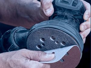 Close up of applying a IRWIN sanding disc with the hook-and-loop backing.