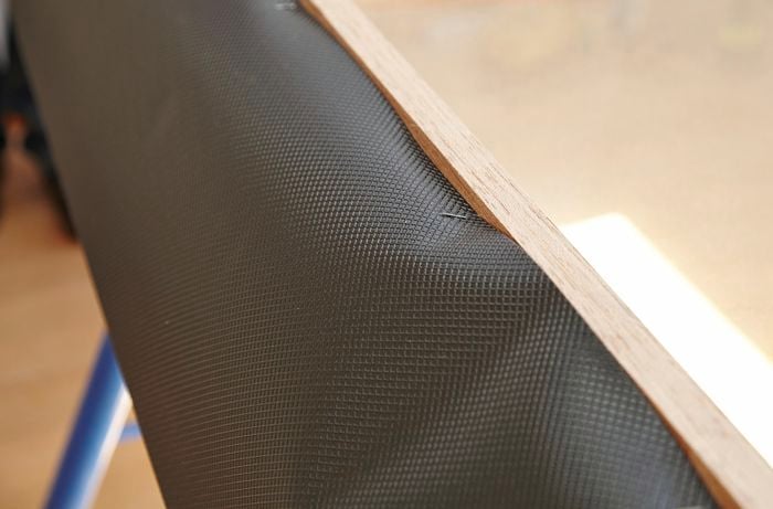 A strip of waterproof flashing stapled onto the rear of the window frame