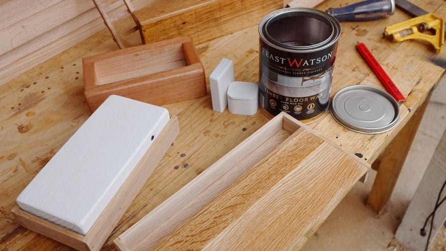 Timber boards with Feast Watson cans of difference stains on display