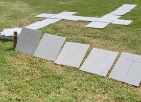 Big pieces of corflute with letters on them, used to spell out a word.