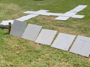 Big pieces of corflute with letters on them, used to spell out a word.