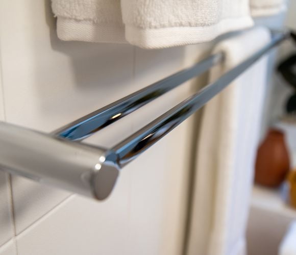 Close up of modern double towel rail holder in chrome colour