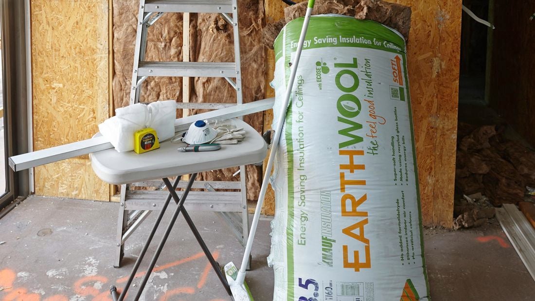 A bag of insulation batts and the tools required to complete this project