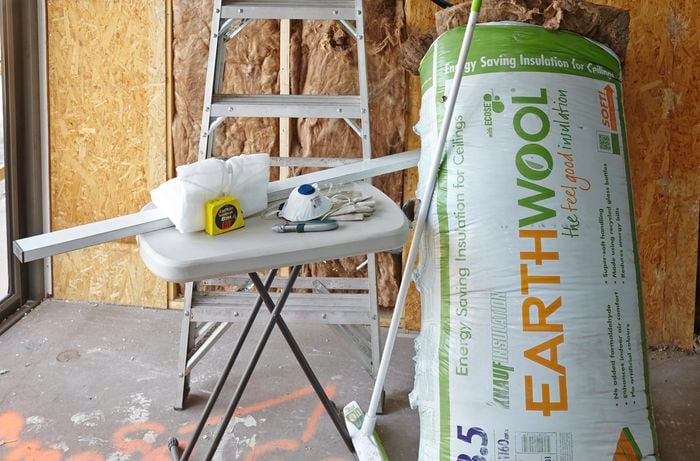 A bag of insulation batts and the tools required to complete this project