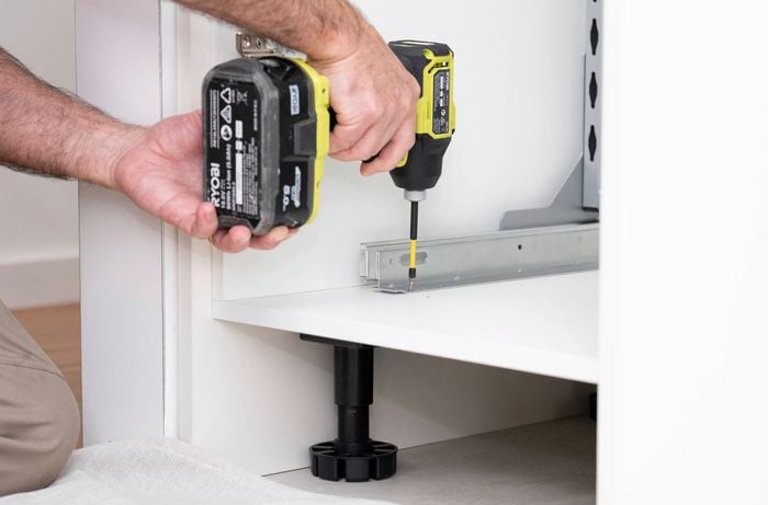 Install the runners in the base of the cabinet