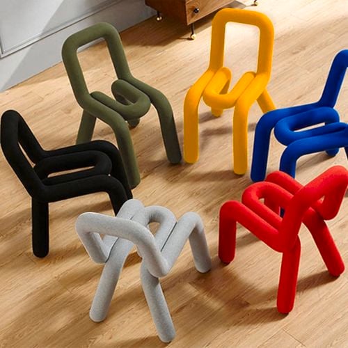 The black BOLD chair makes a striking statement with its sculptural, looped silhouette and plush tubular form.