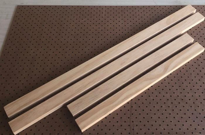 Four lengths of timber sitting on a pegboard