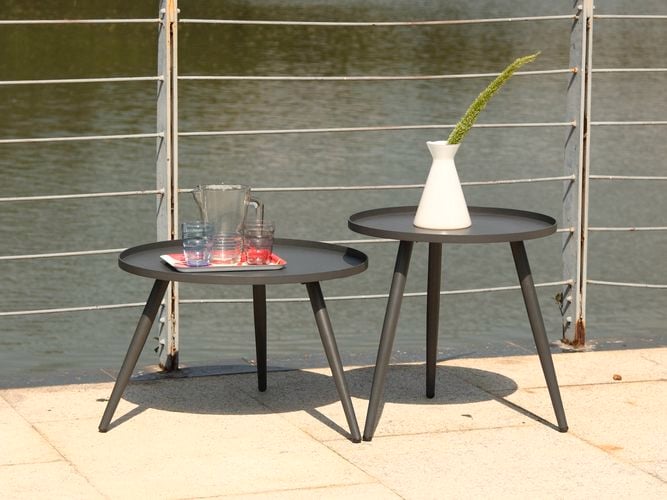 A cast aluminium outdoor dining setting with two armless chairs and a table