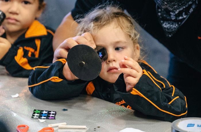 A child using a completed Matariki kaleidoscope