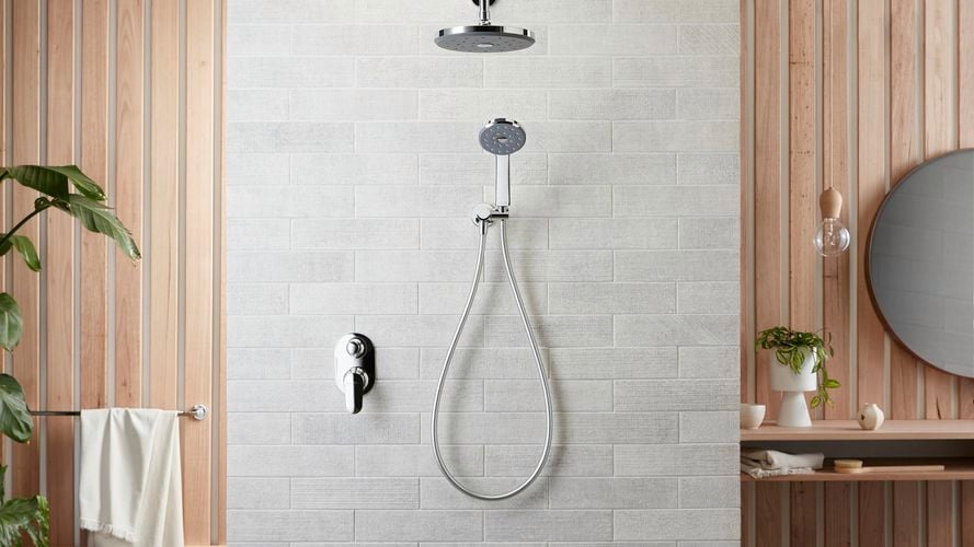 Tiled shower with showerhead and hand mixer in chrome with side timber panels
