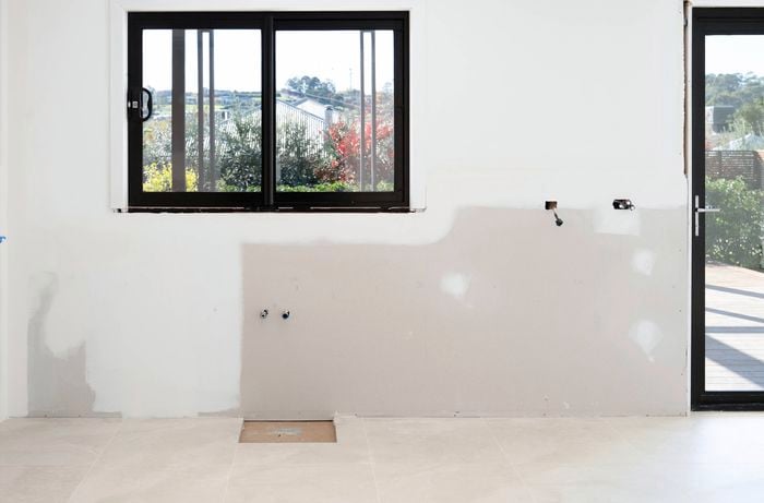 A wall under construction shows key features, highlighting the need for precise edge-to-edge measurements.