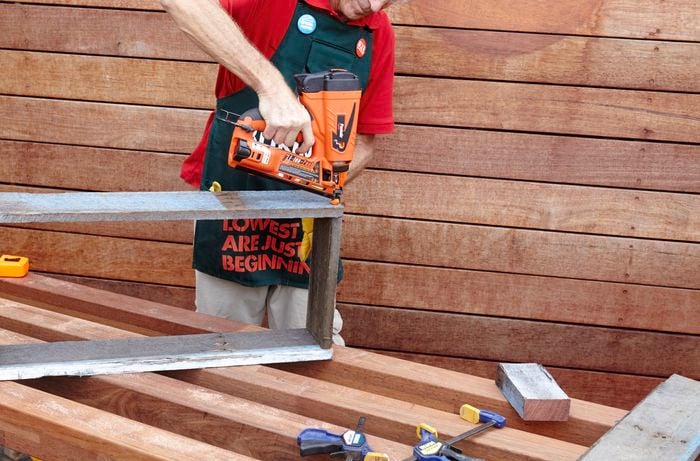 The frame of a herb planter being assembled by a Bunnings team member with a nail gun