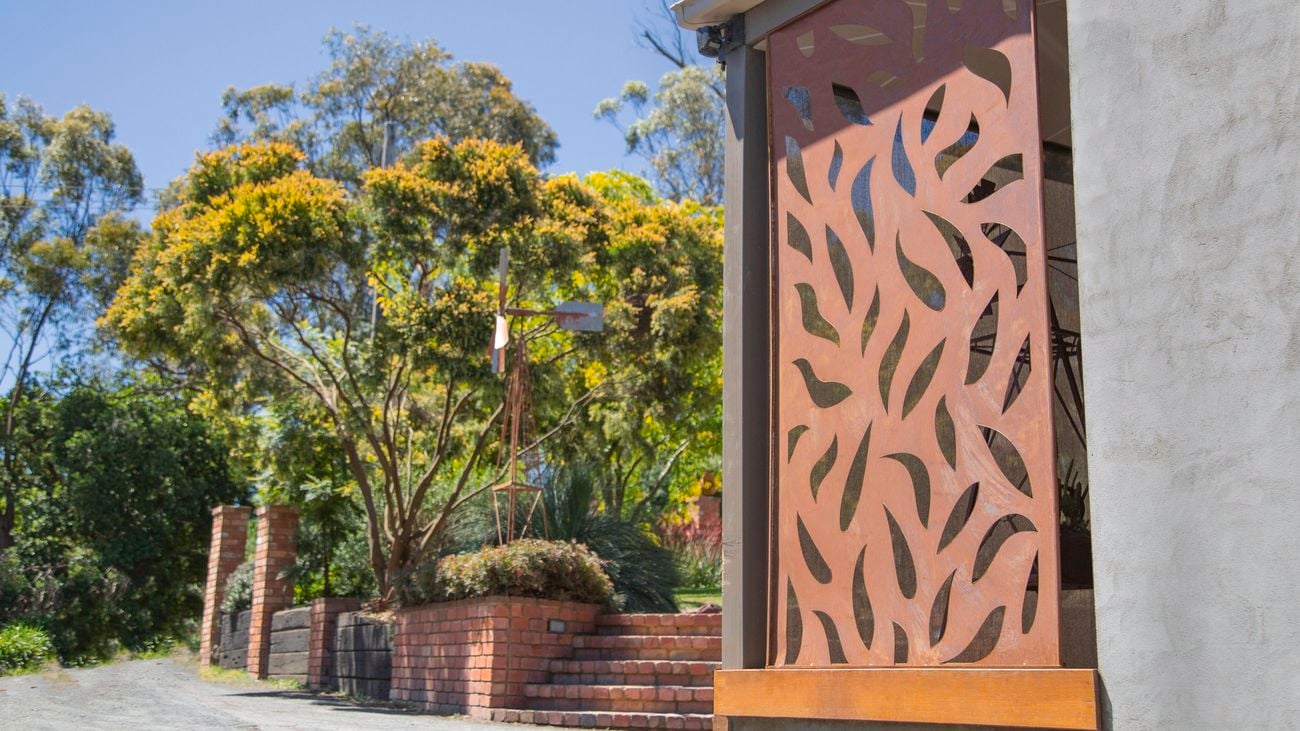 outdoor garden with brick fence and privacy screen