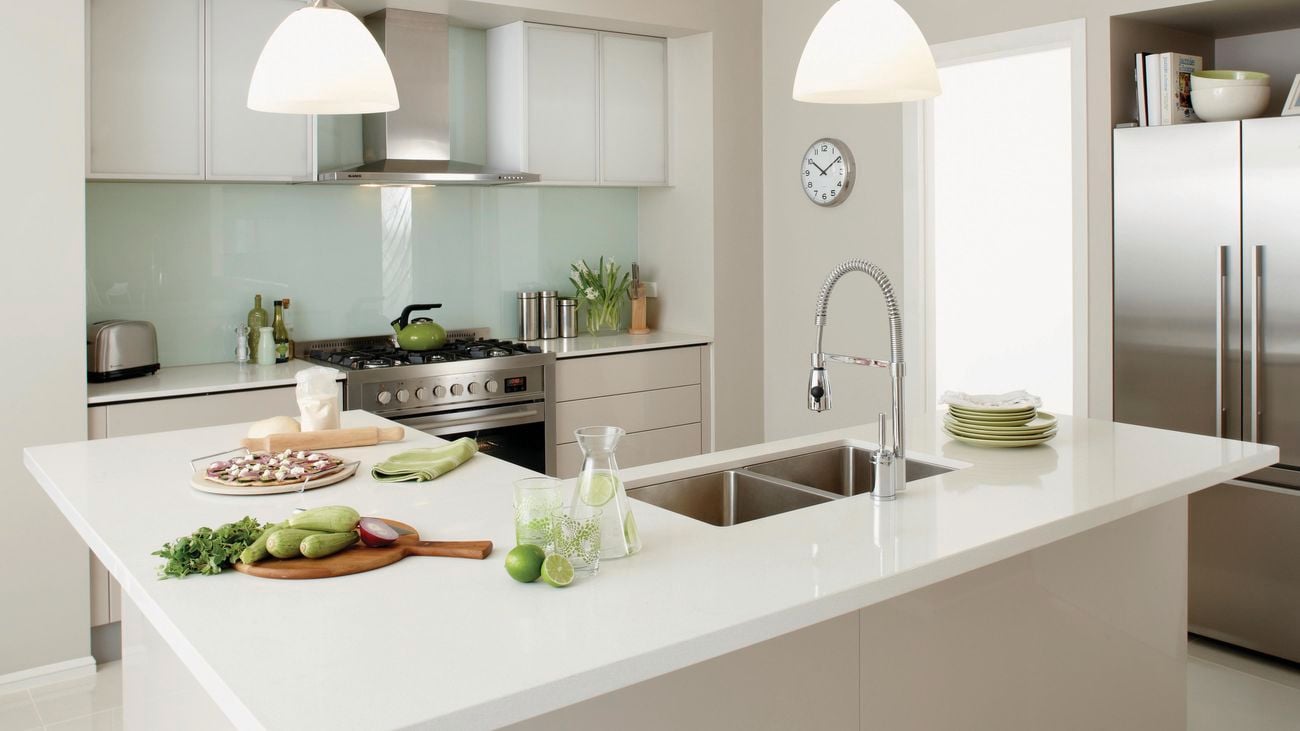 Kitchen featuring a large island with a dark undermount sink.